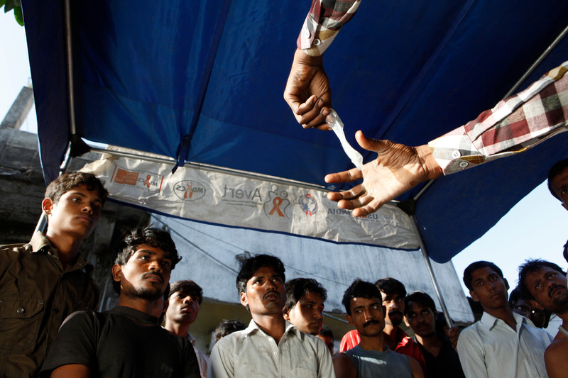 Condom demonstration to a group of men in rural India