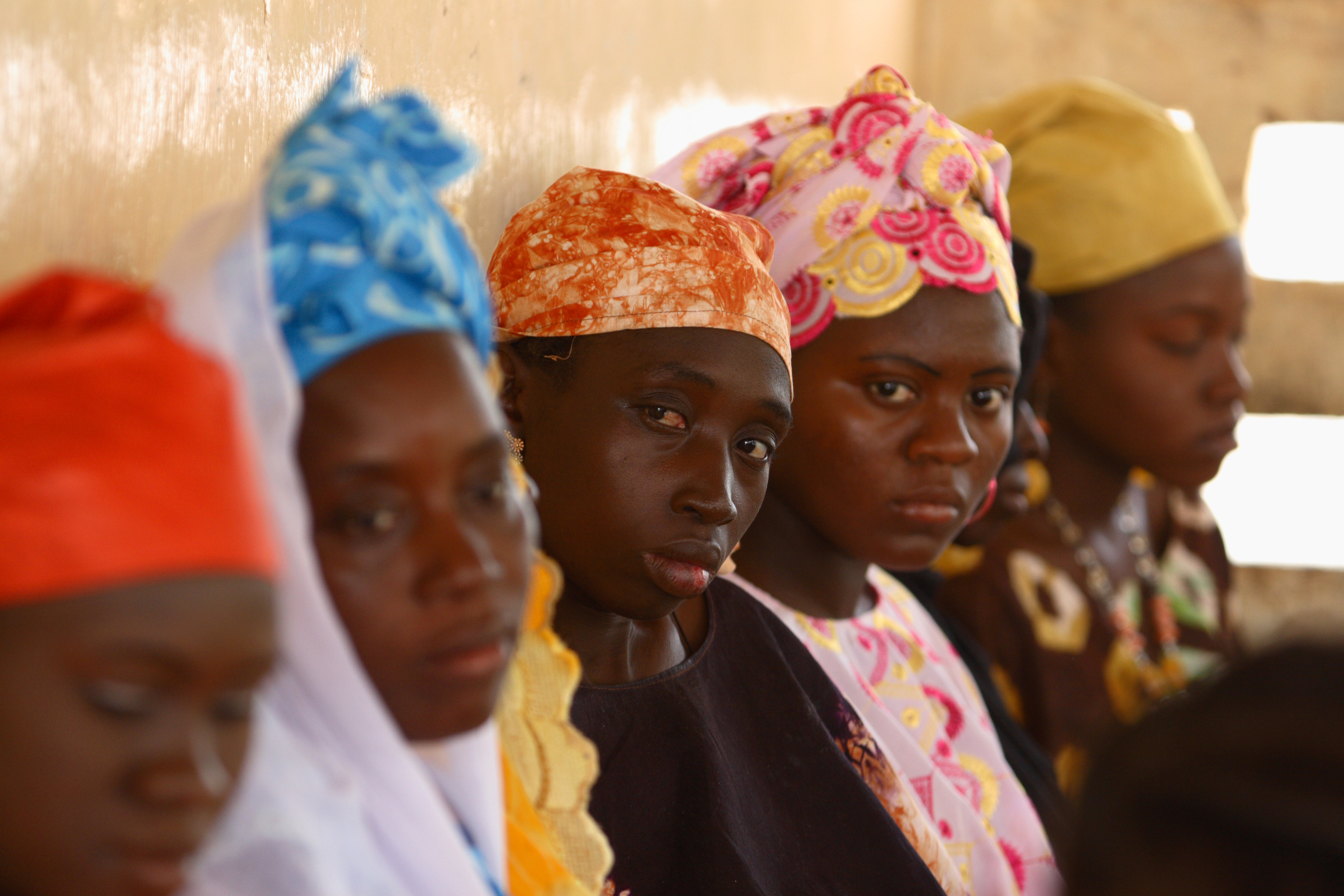 Four black women, looking at the camera. Gambia, ph:Chloe Hall