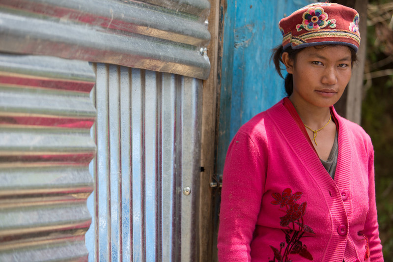 Young woman outside her home in Nepal. 
