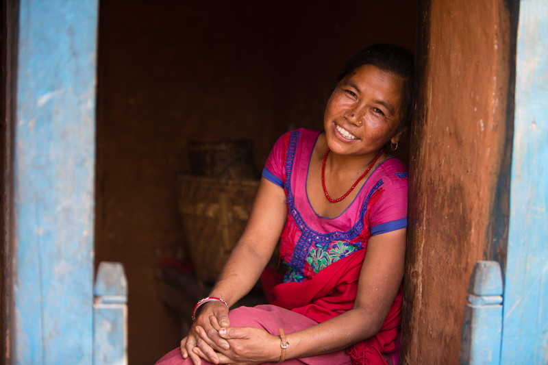 Woman sitting outside her home 
