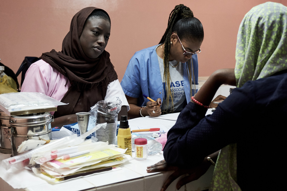 A midwife talks to a client in Senegal 