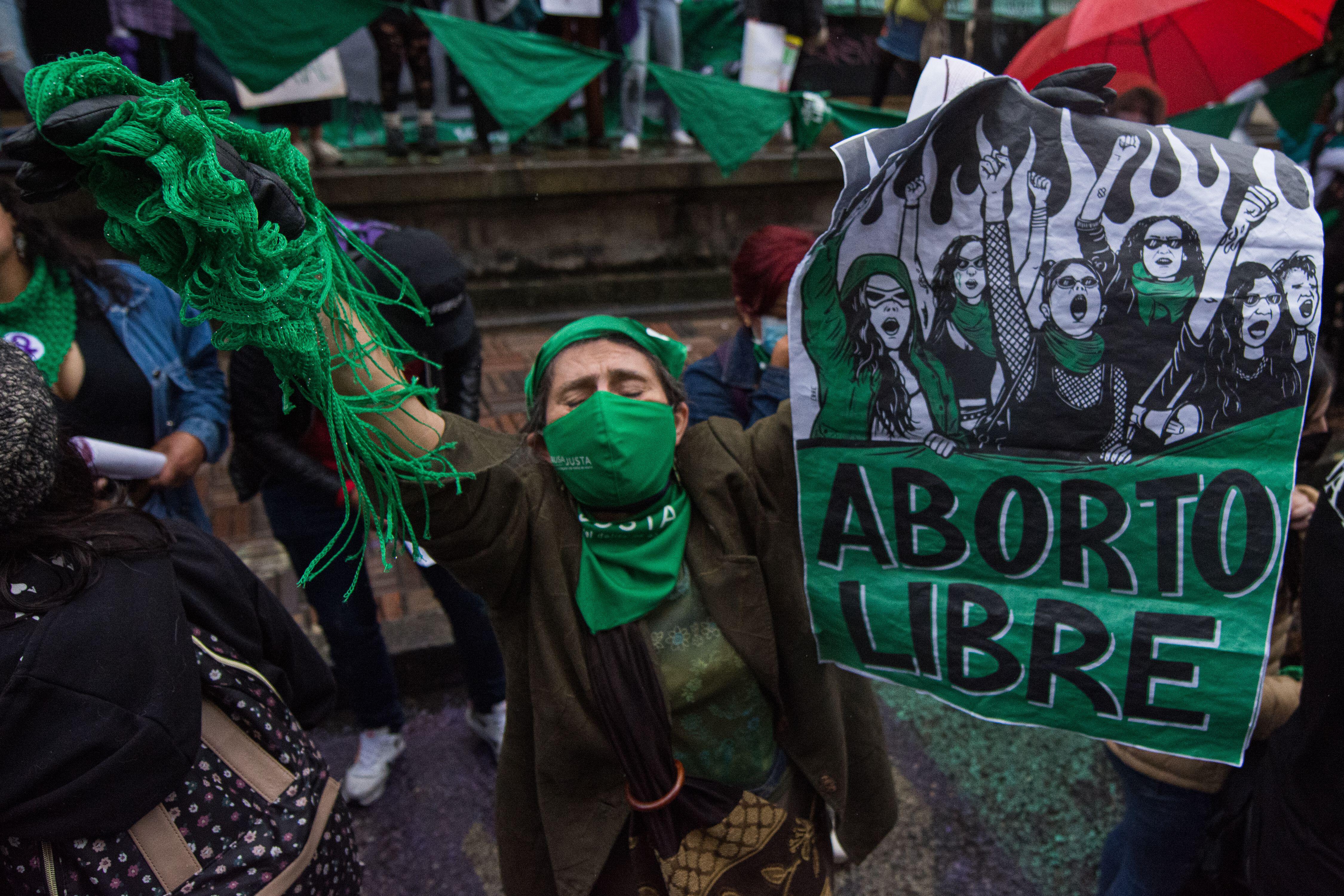 woman holding green flag from the Latin American feminist movement 