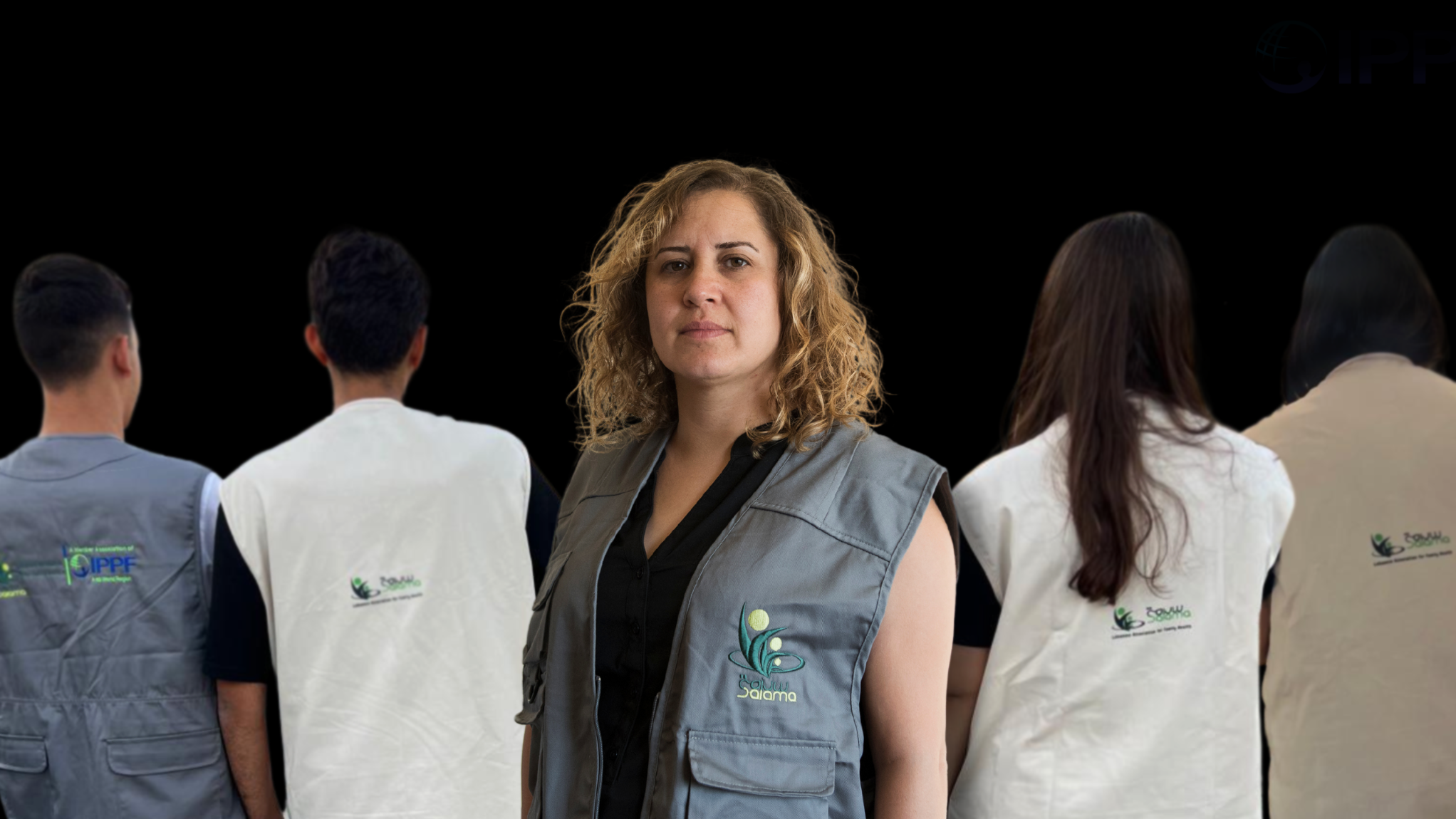 A portrait of Lina Sabra standing with volunteers.