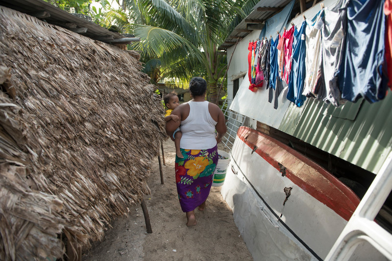 Woman walking with baby.