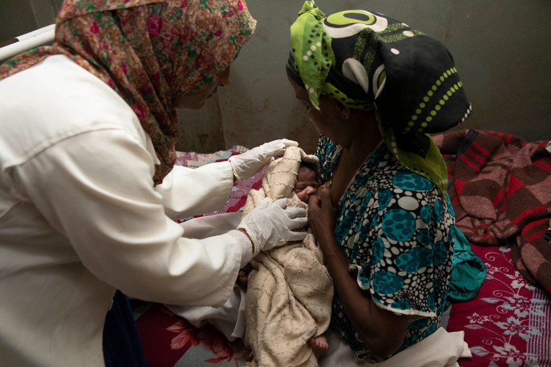 Rewda with a newborn baby and their mother