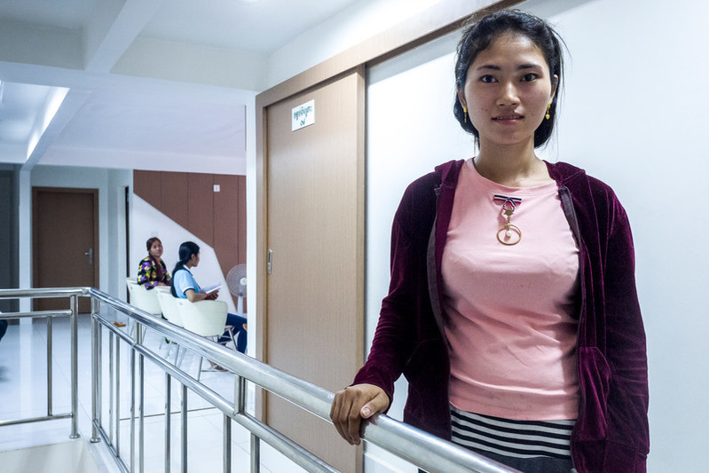 Garment worker Doung Sreynith, 22, after her check-up with midwife, Chan Vanna. She is two months pregnant. Sreynith is attending the RHAC clinic for the first time after her sister recommended the clinic. She had heard positive things about RHAC doctors paying more attention to their patients than in other clinics. Sreynith did not know anything about reproductive health before but feels confident to share her opinions with friends and family. 