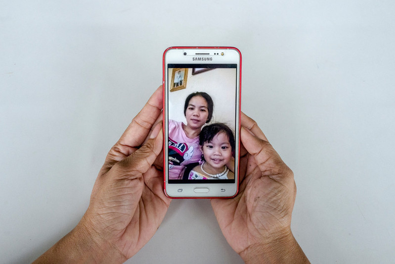Garment worker Sek Sophorn, 34, shares a photo of her with her 4-year-old daughter Kanika during a break. 
