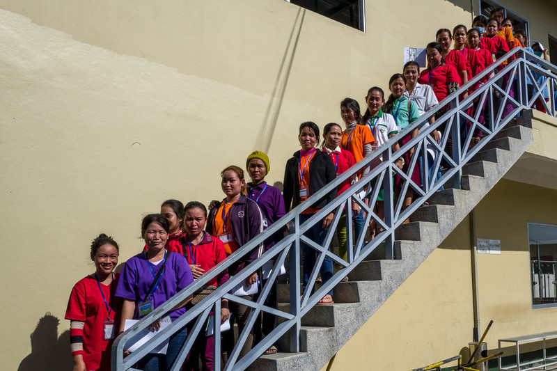 RHAC staff and a group of garment workers outside the recreation room of the Dewhirst Garment Factory following a group discussion. RHAC organizes participatory events with garment workers, which are very popular.  