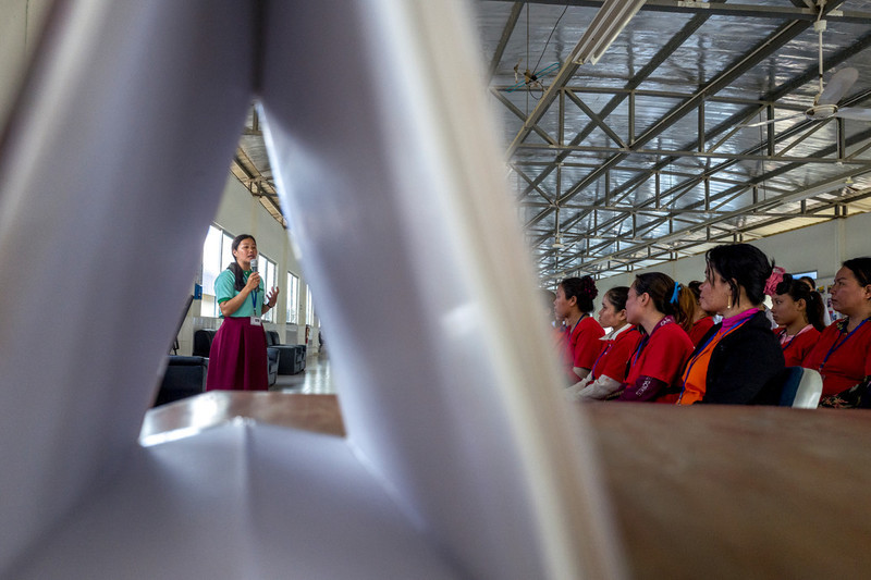 RHAC demand generation officer, Sophal Im, speaks to a group of garment workers during a group discussion. Im has been working for RHAC for the last year and received four training sessions; she now feels very confident about speaking to other women about reproductive health. 