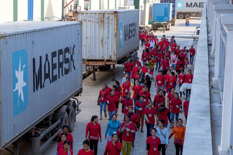 Garment workers exit one of the production line wards at the end of their shift at the Dewhirst Garment Factory.