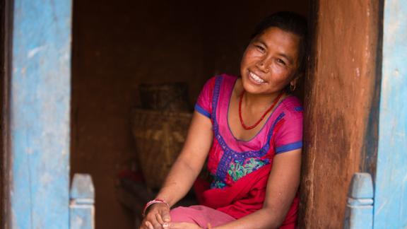 Woman sitting outside her home 
